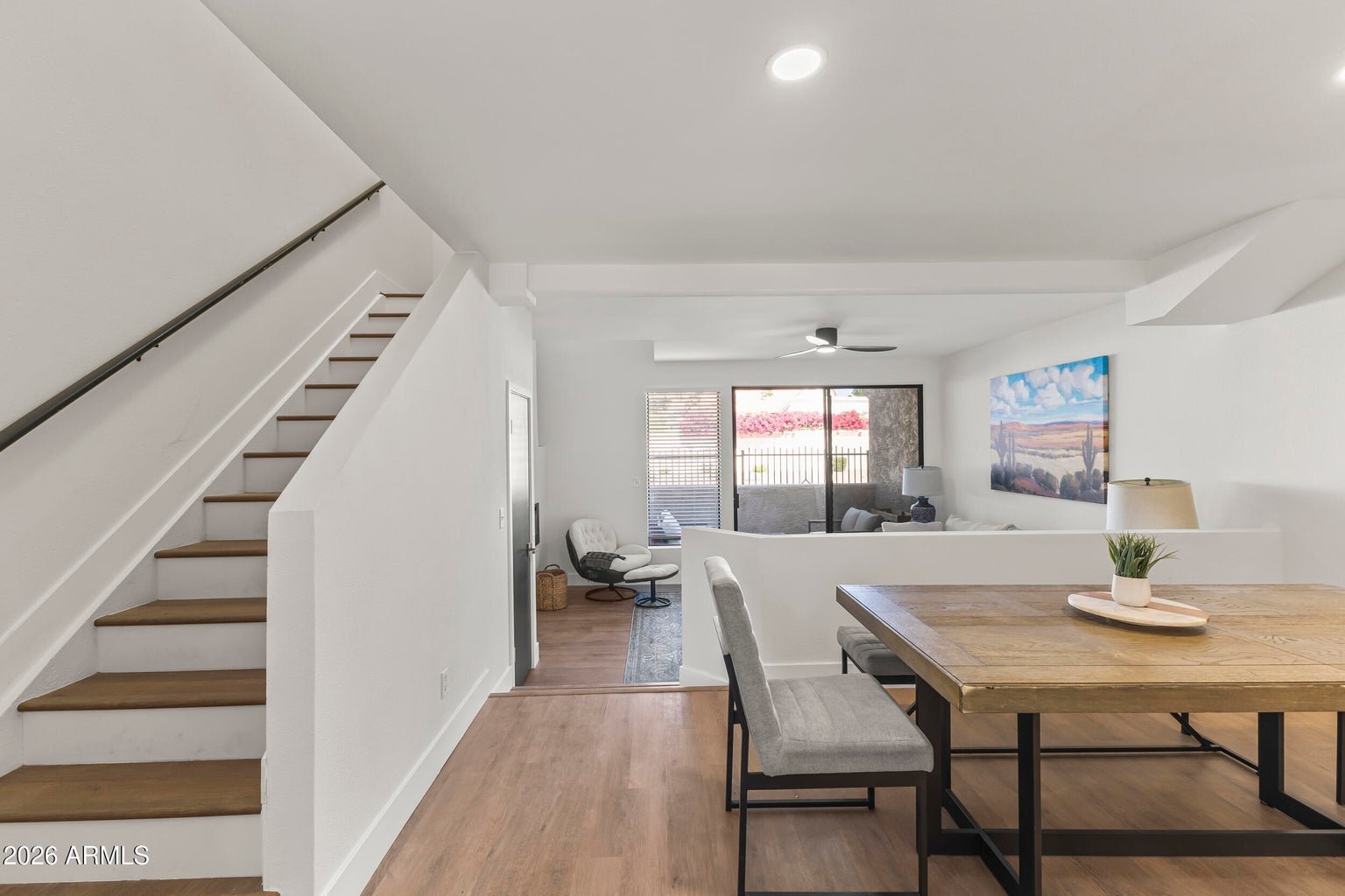 Living room and formal dining area with stairs to the second level