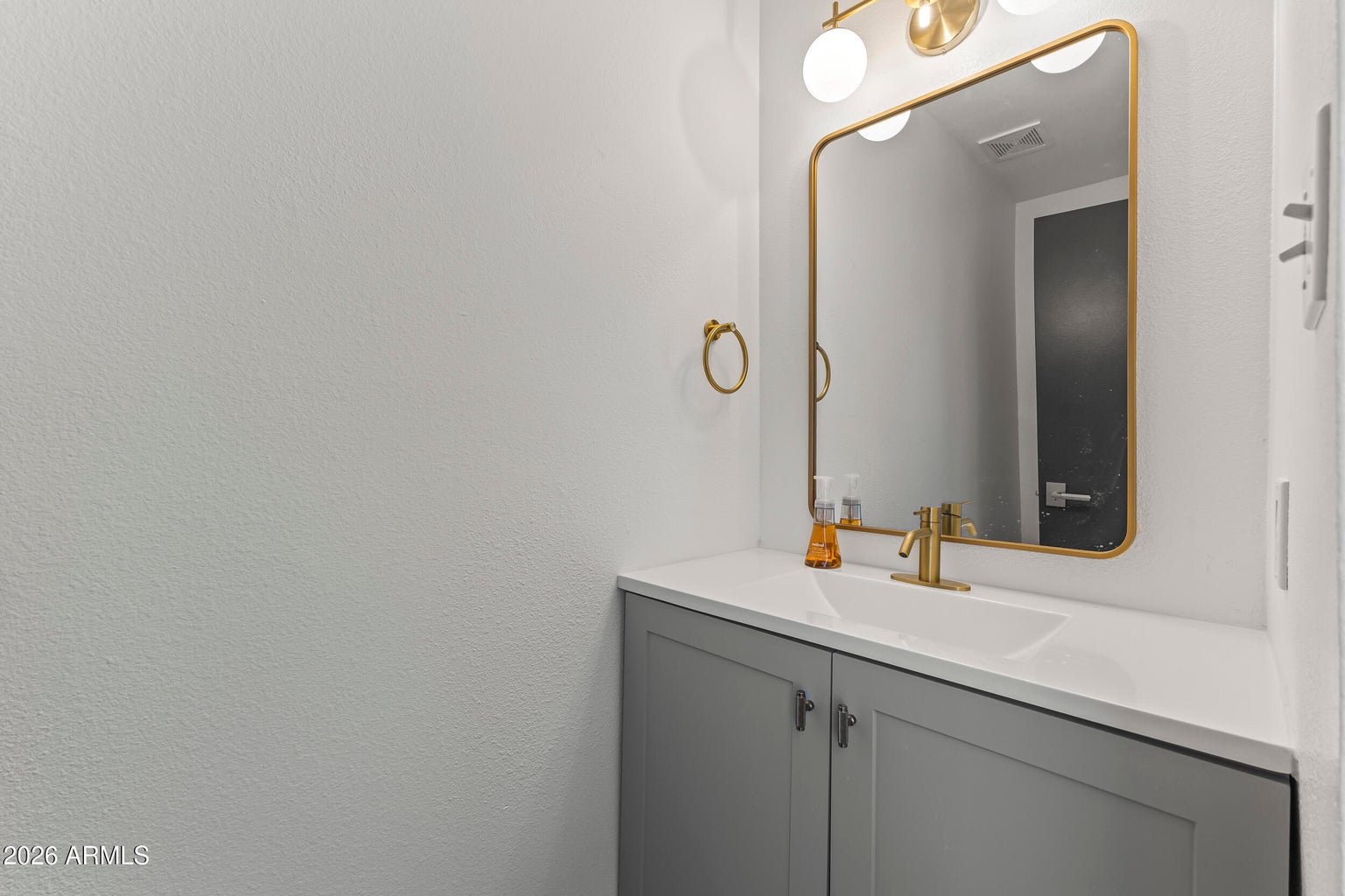 Powder bathroom with gold fixtures