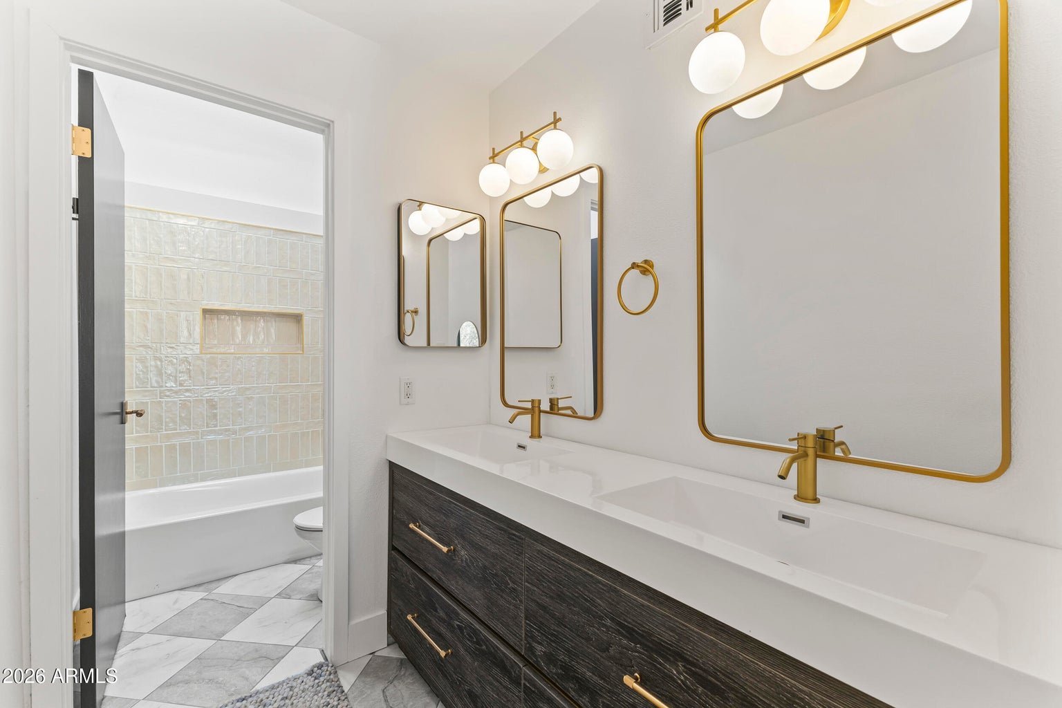 First primary bathroom with a dual vanity and gold fixtures