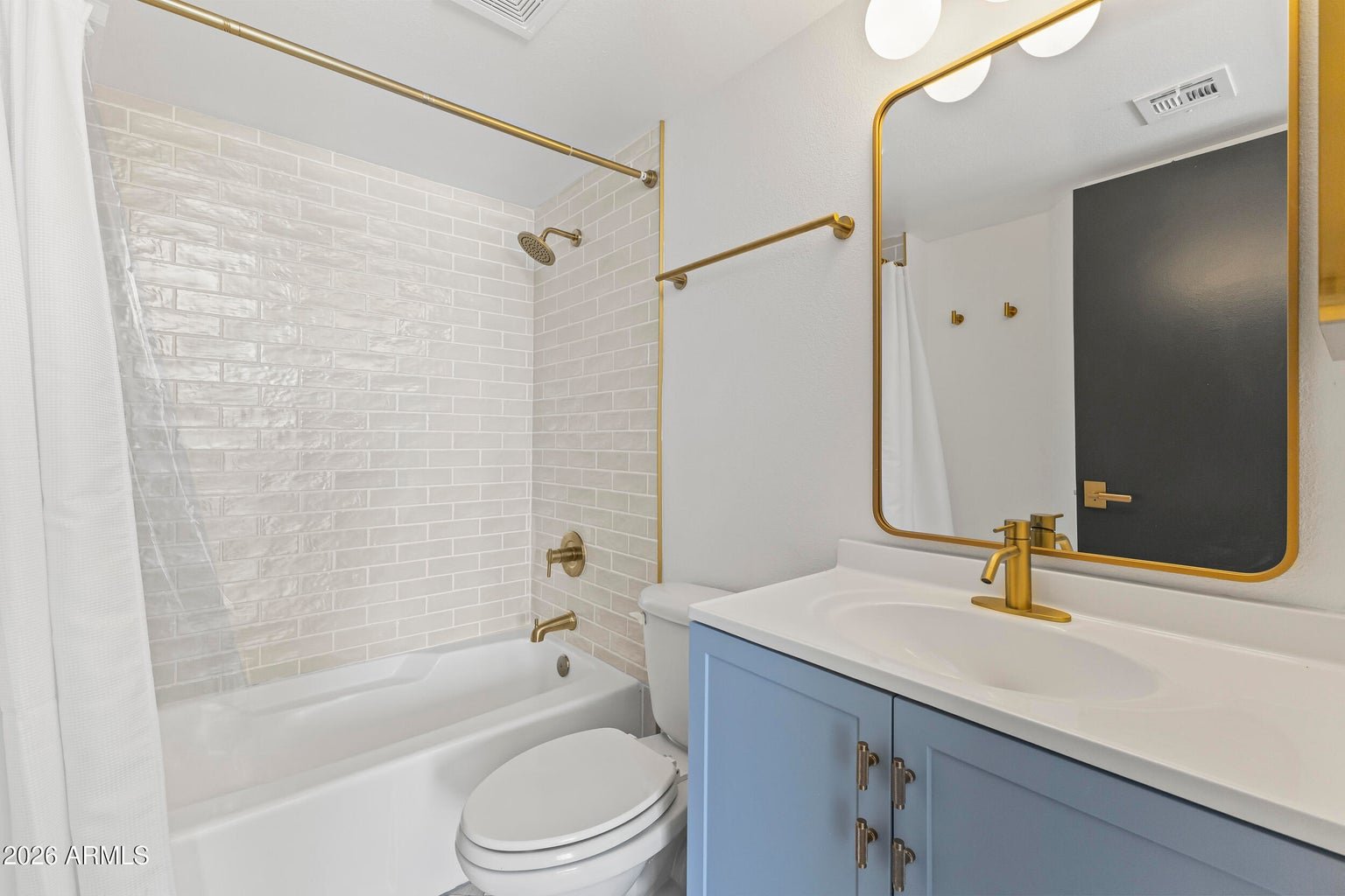 Second primary bathroom with a soaking tub and vanity