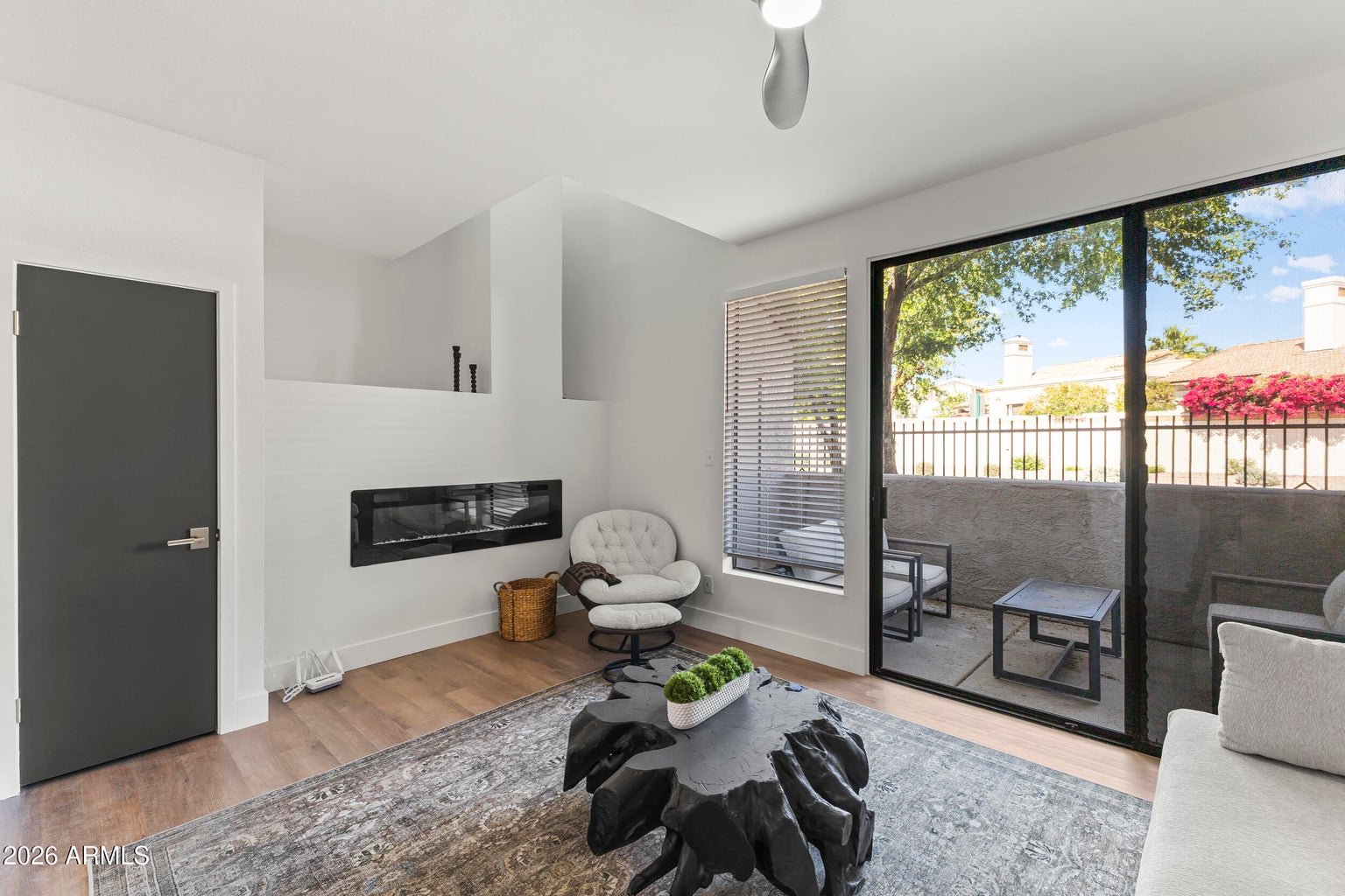 Sunken living room with a fireplace and patio access