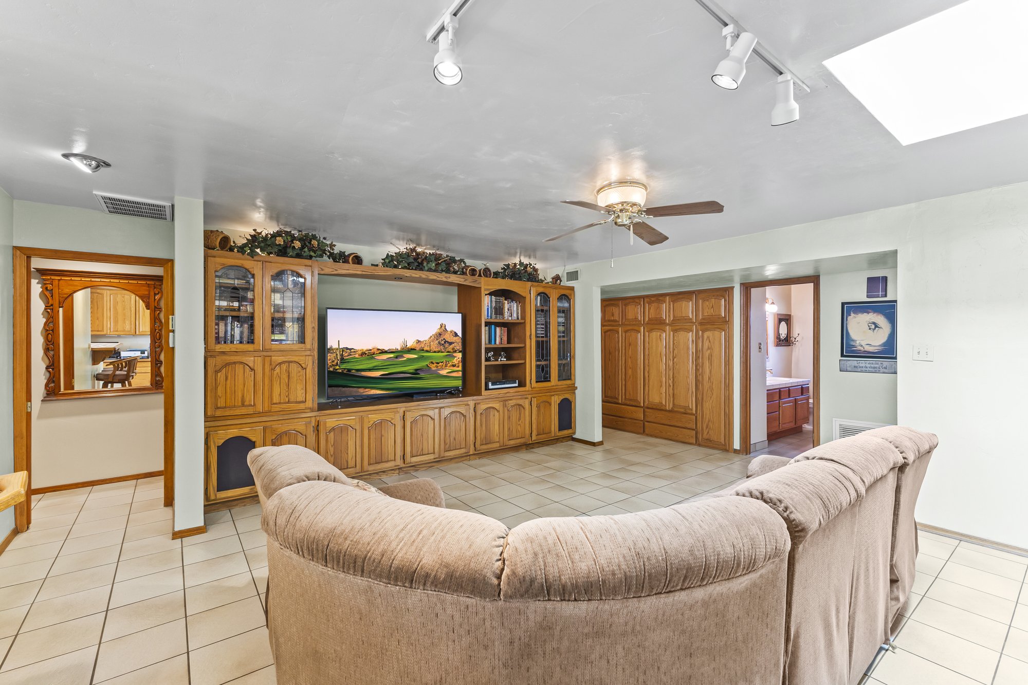 Family room with skylights and built in cabinetry