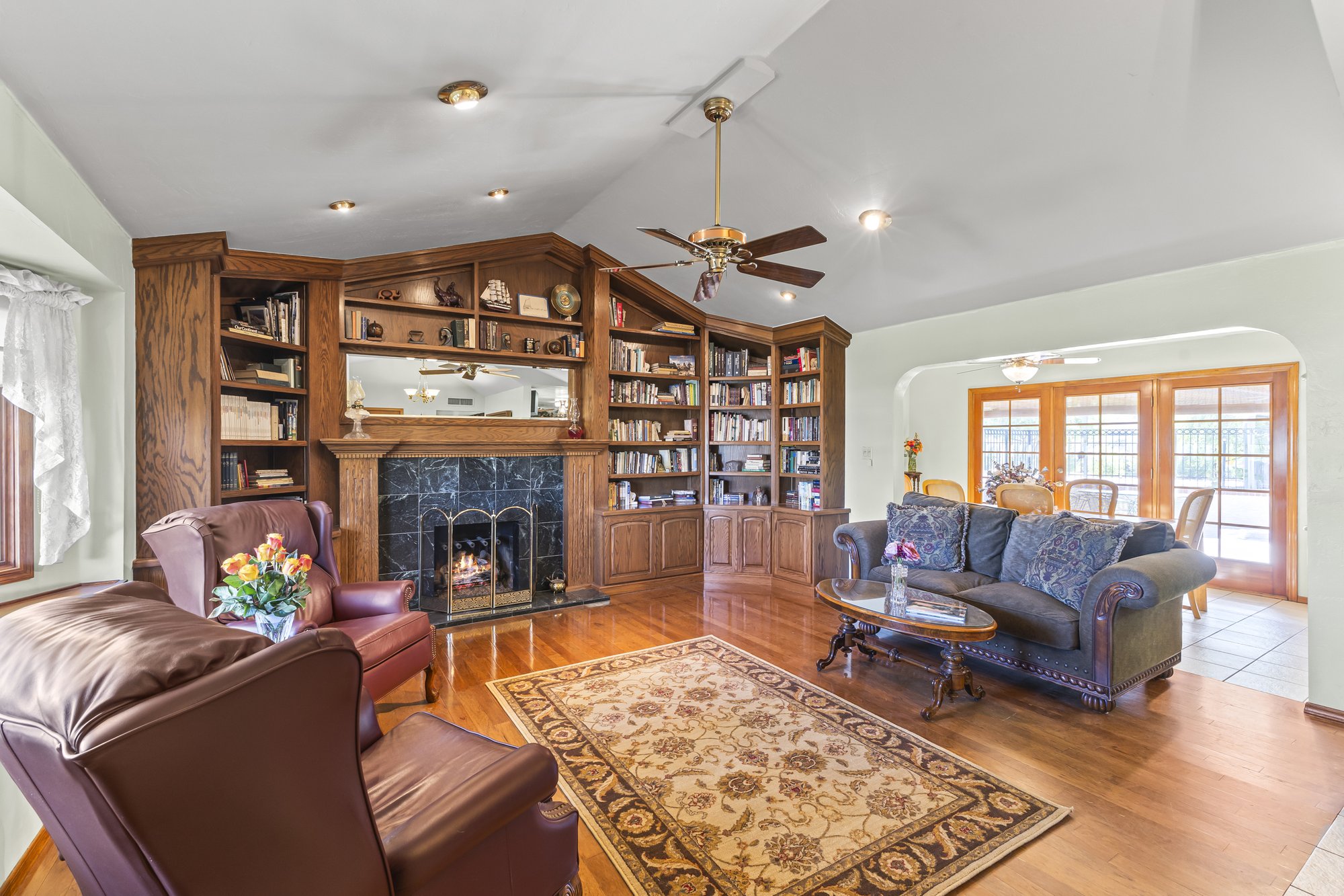 Living room with a gas fireplace and custom built in shelving