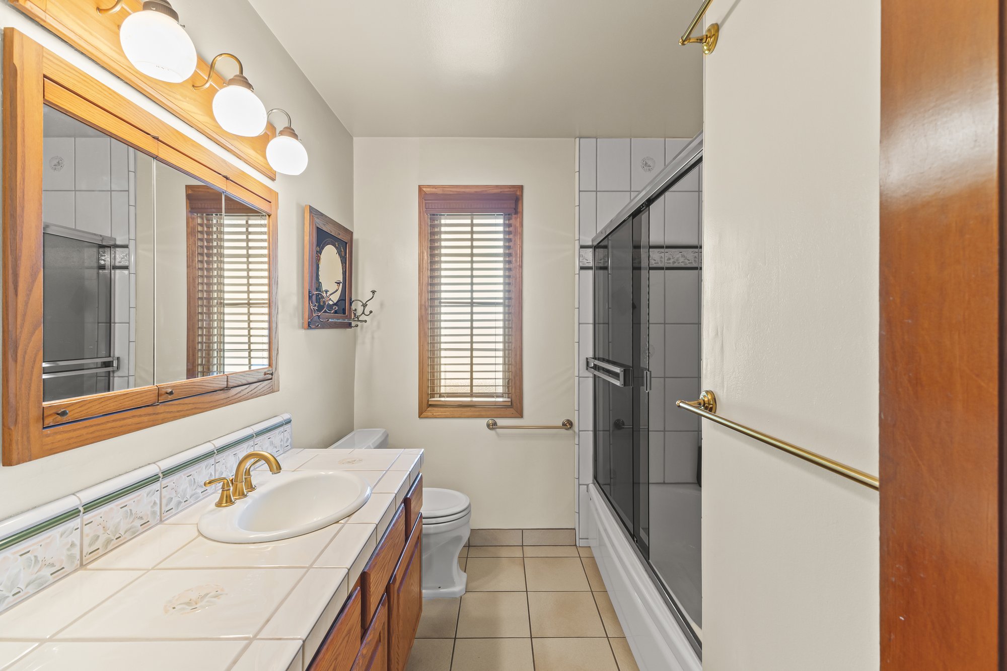 Bathroom with a tiled shower and vanity