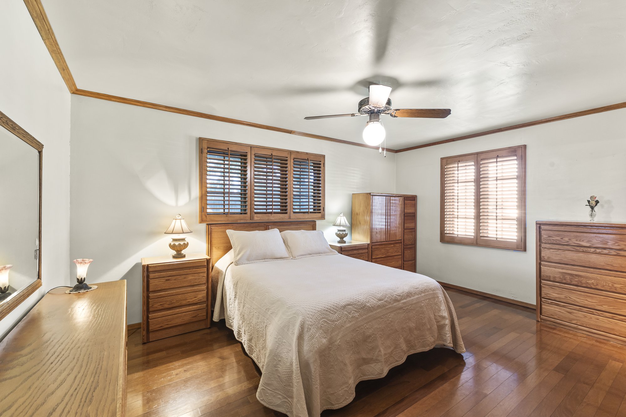 Primary bedroom with wood furniture