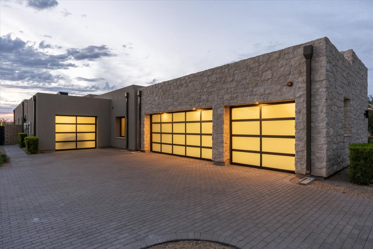 Front exterior and 4 car garage at twilight