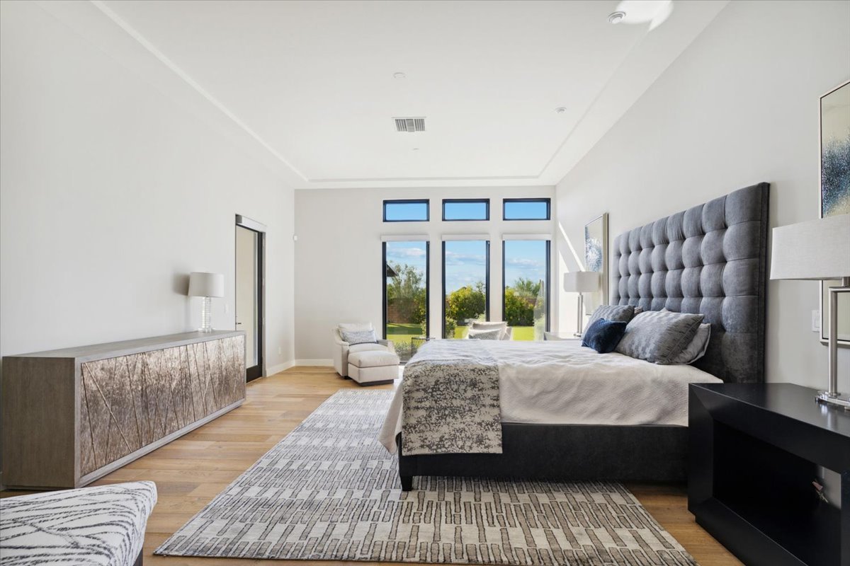 Primary bedroom with large windows
