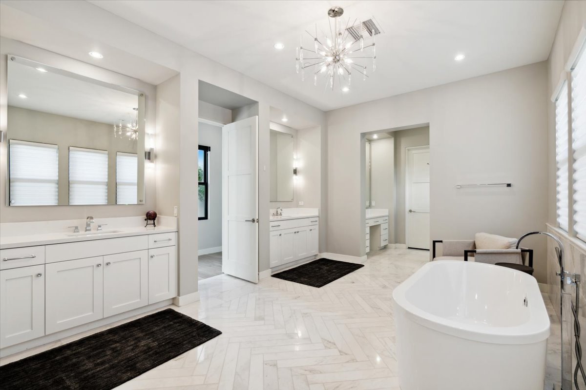 Primary walk in closet with mirrored built ins