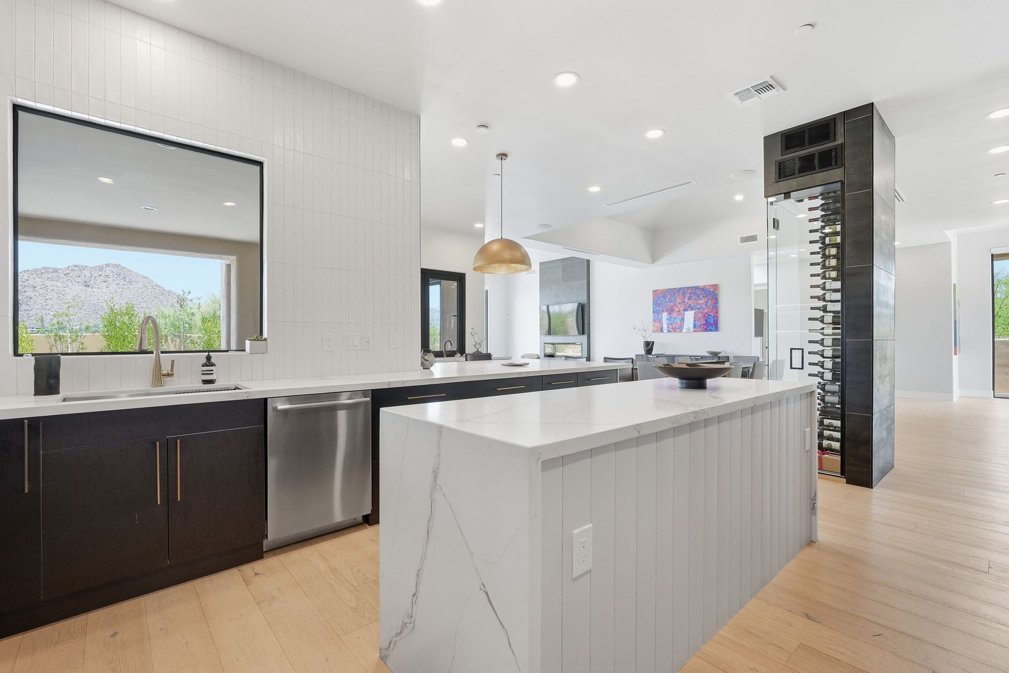 Kitchen with a waterfall edge island and dark cabinetry