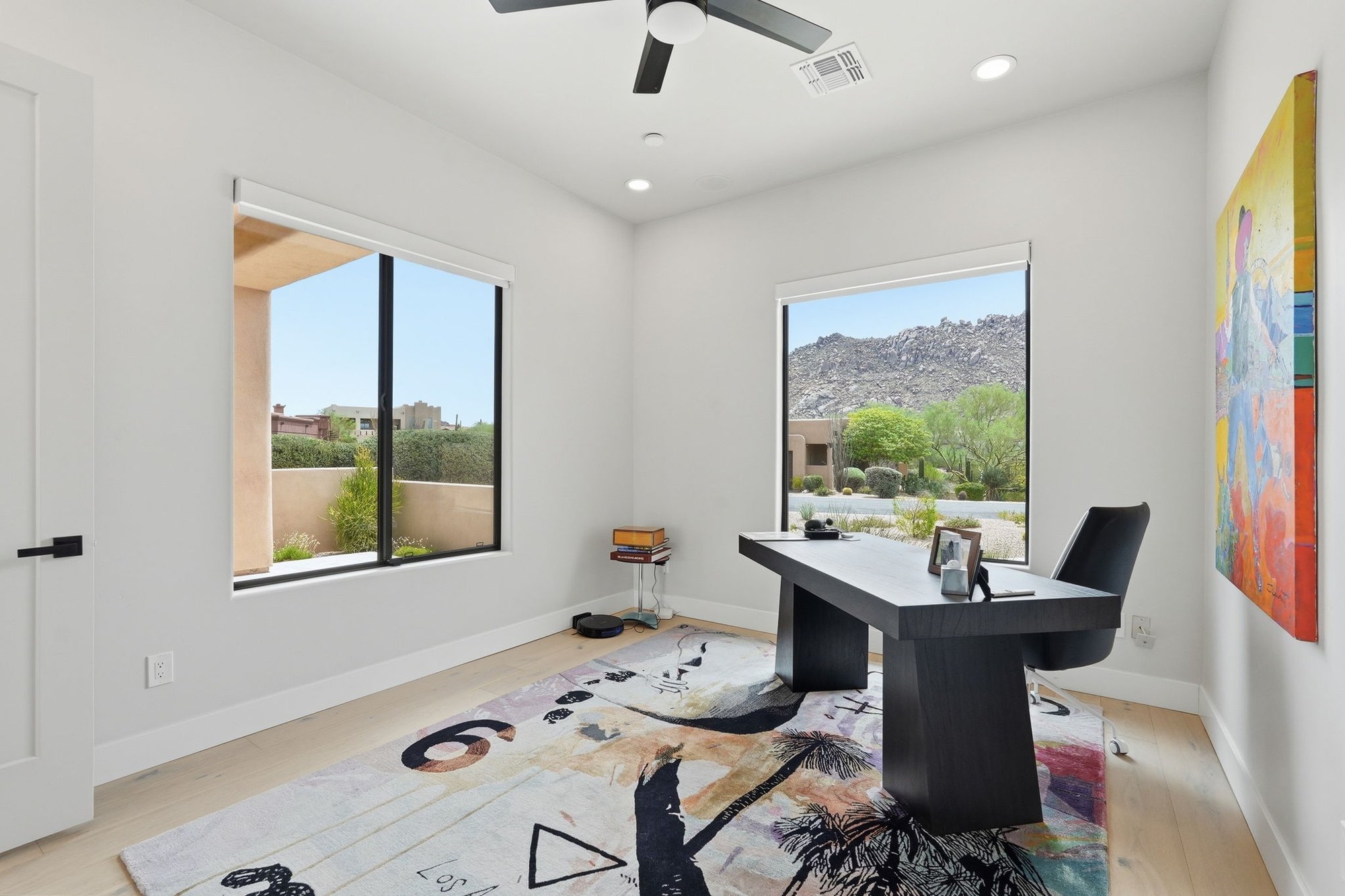 Bedroom with a desk, styled as a home office, with mountain views