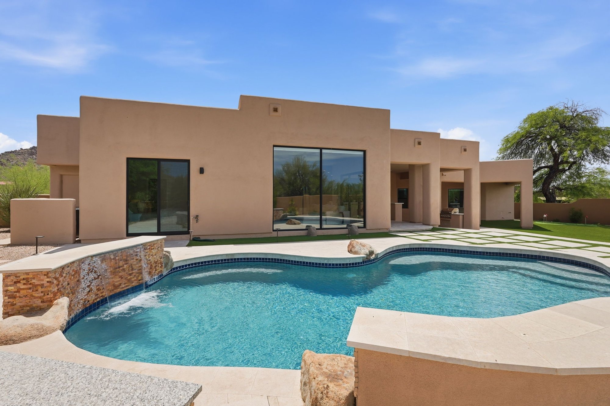 Aerial view of the pool and backyard with mountain views