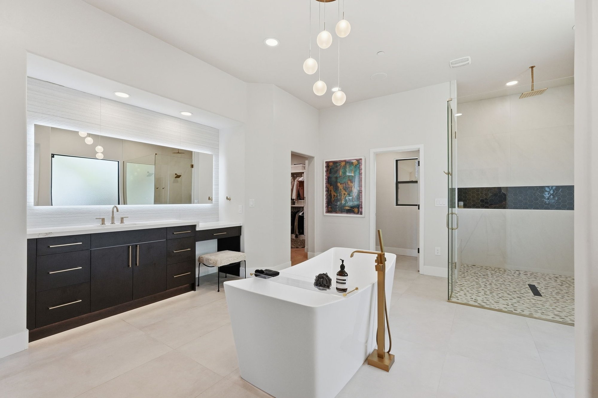 Primary bathroom with a freestanding soaking tub and dual vanity