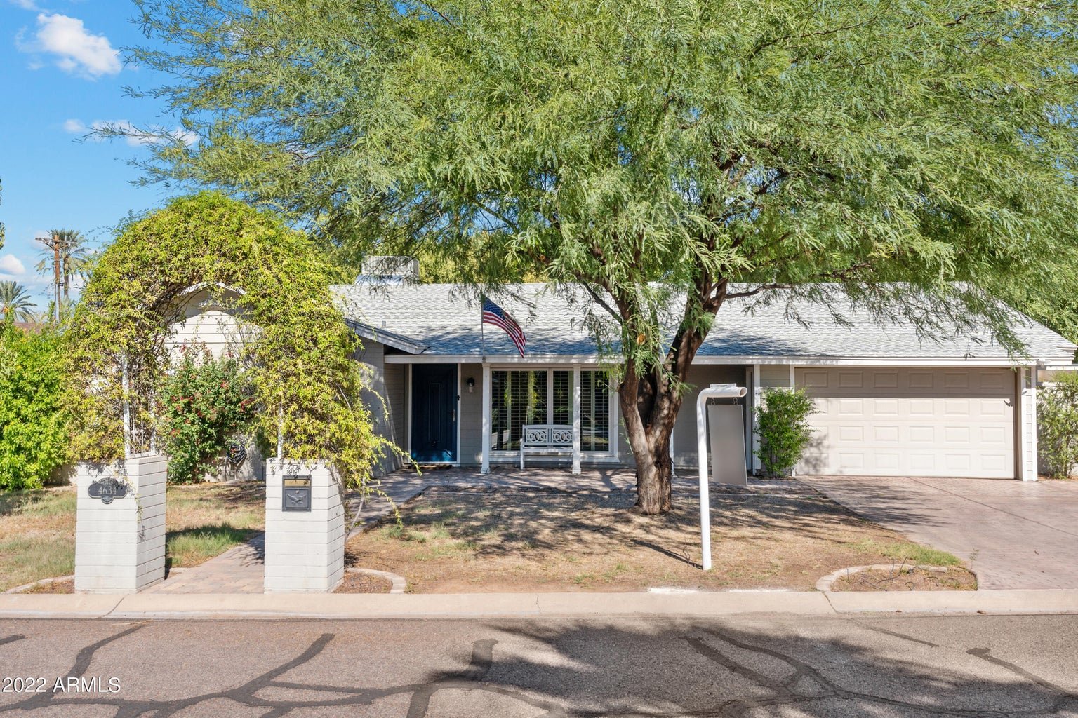 Front exterior with mature trees and landscaping