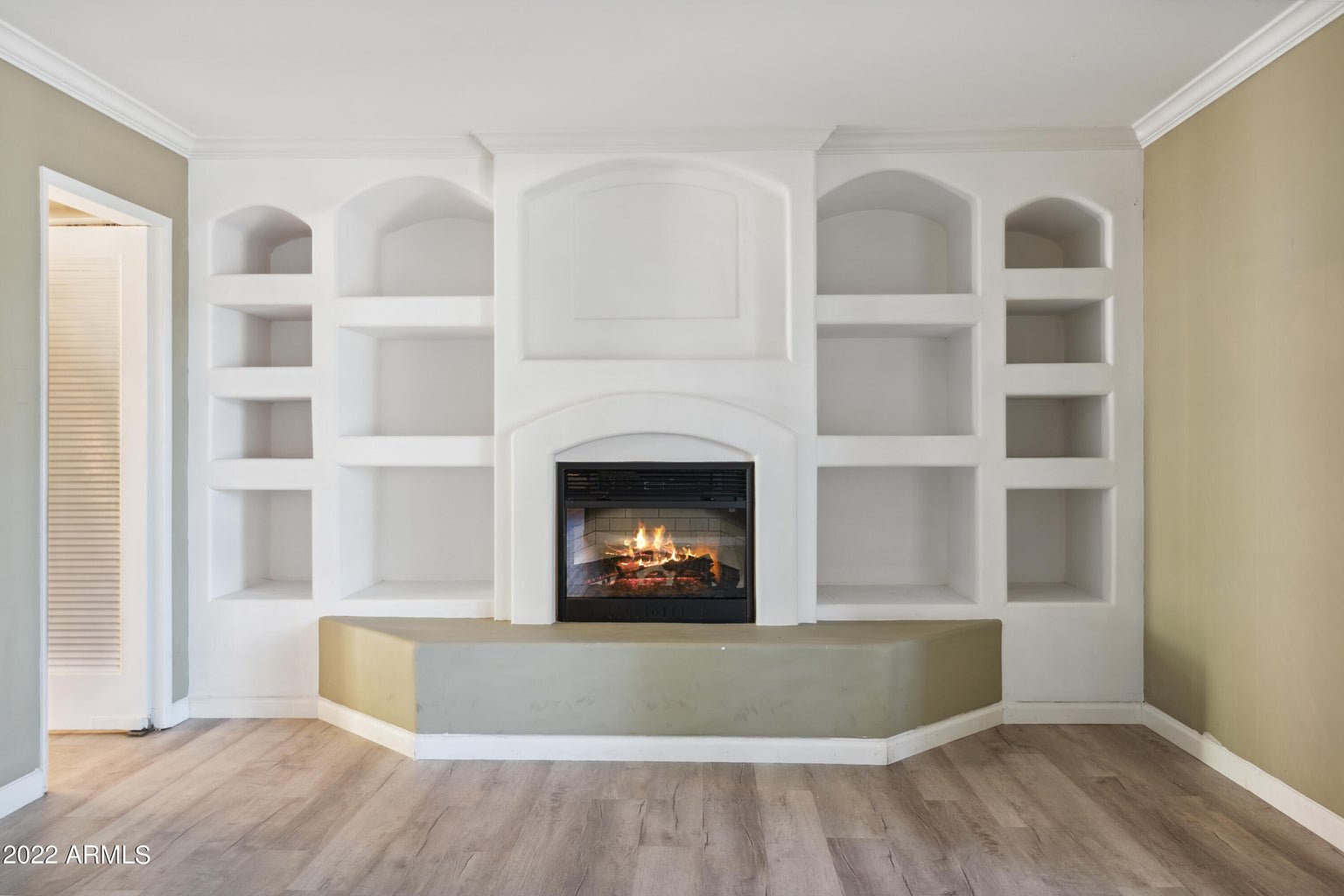 Formal living room with built ins framing a fireplace