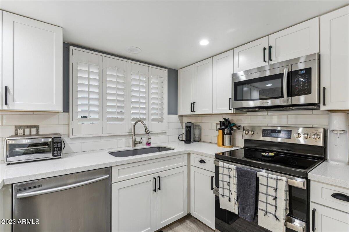 Kitchen with white cabinetry and quartz countertops