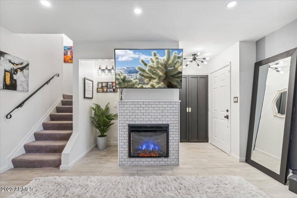 Living room with a new electric fireplace near the stairs