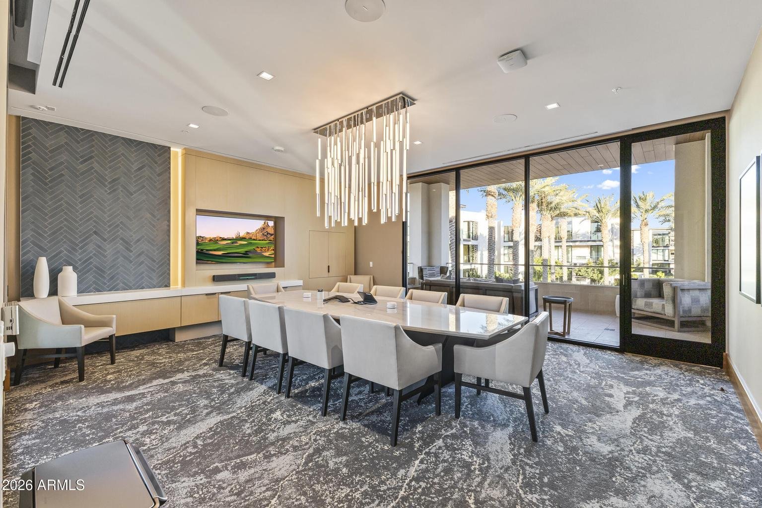 Living and dining area with coffered ceiling and courtyard views