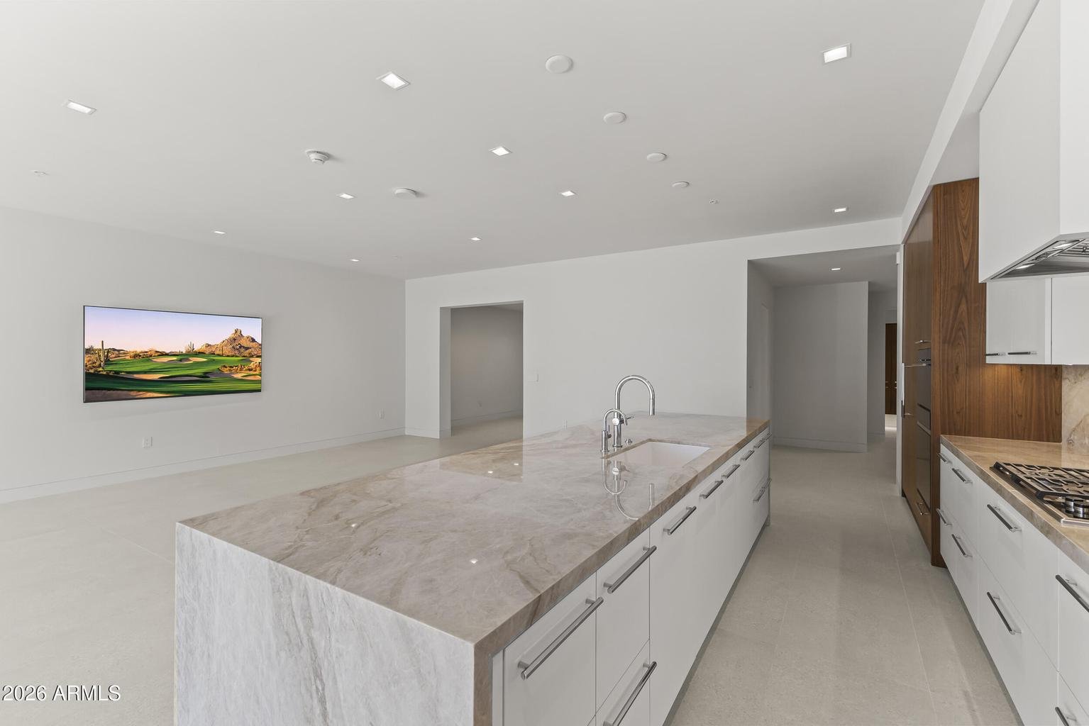 Open concept kitchen and great room with wood ceiling accent