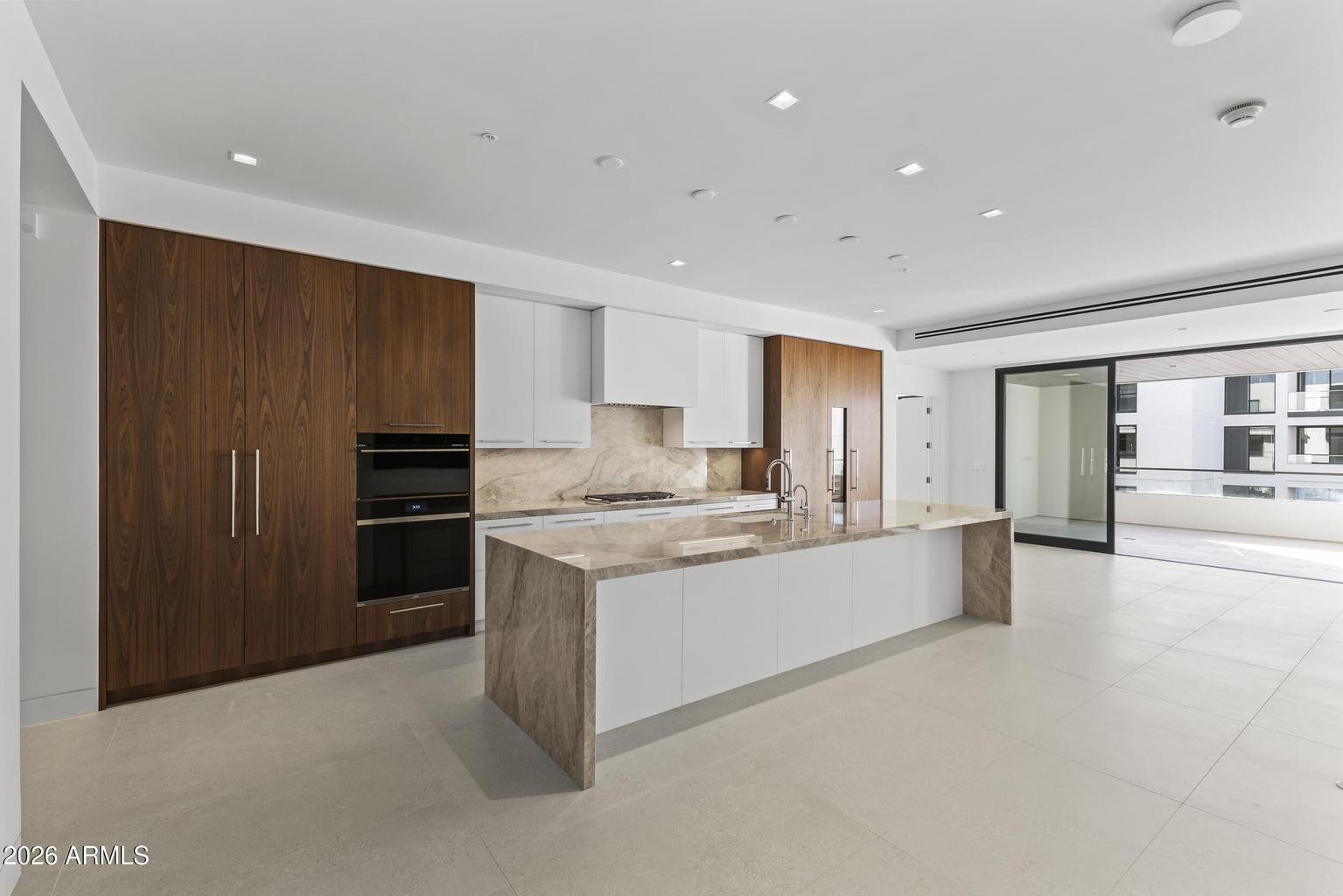 Villa kitchen with Wolf appliances, quartzite island, and walnut cabinetry