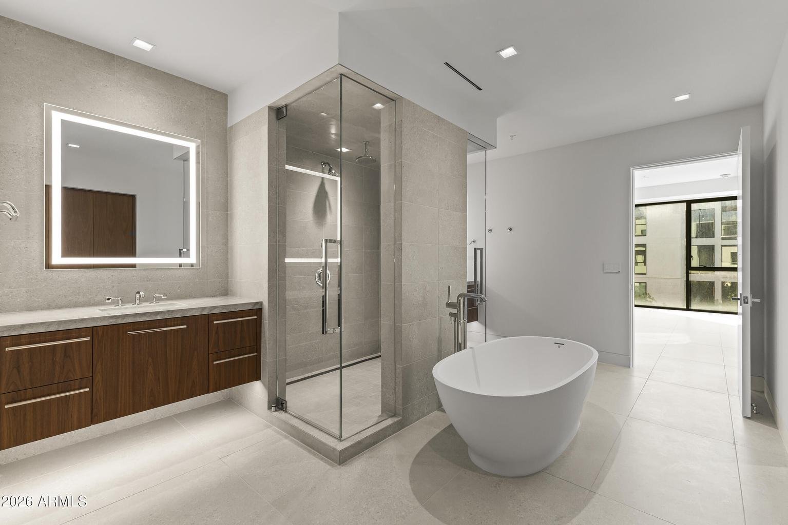 Primary bathroom with freestanding soaking tub and glass shower