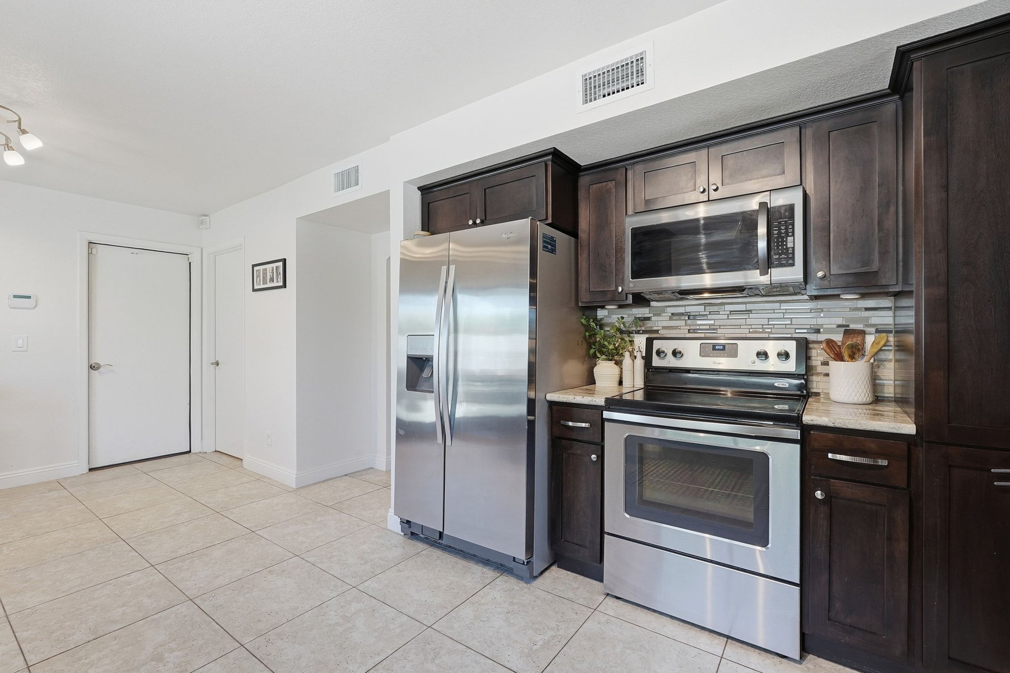 Kitchen stainless steel appliances and cabinetry detail
