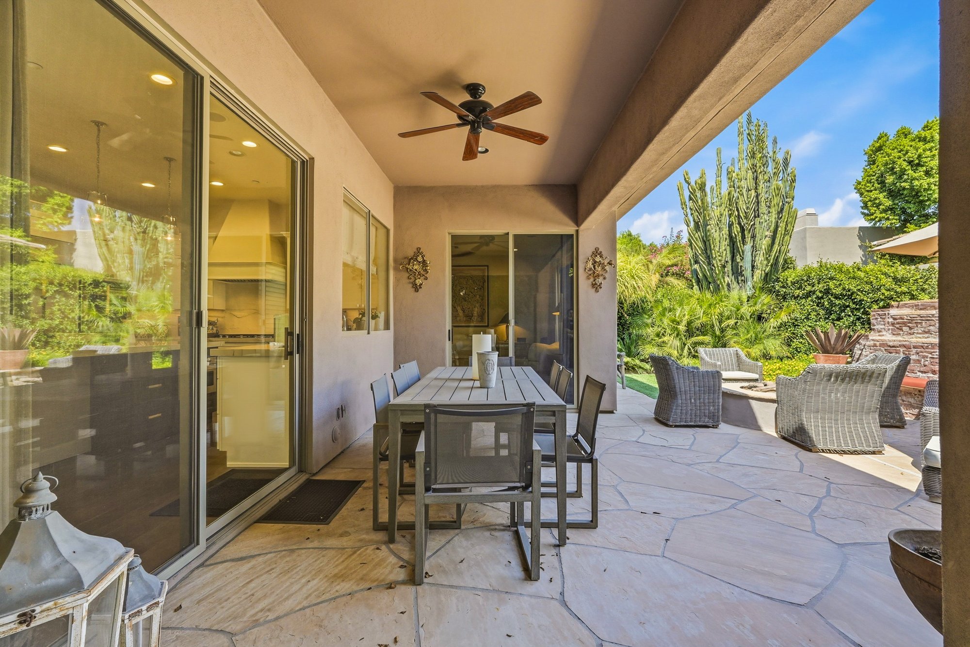 Covered patio with outdoor dining and seating areas