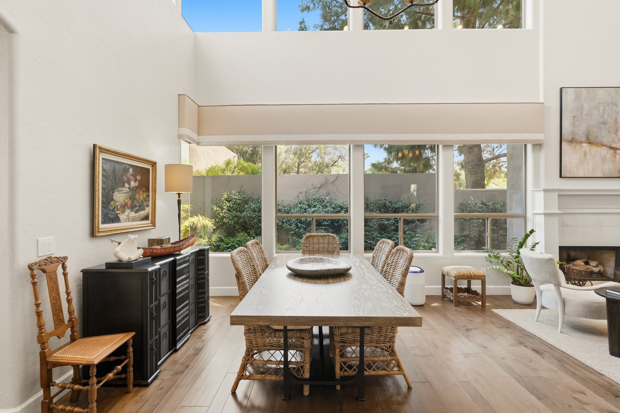 Dining area open to the living room with a fireplace