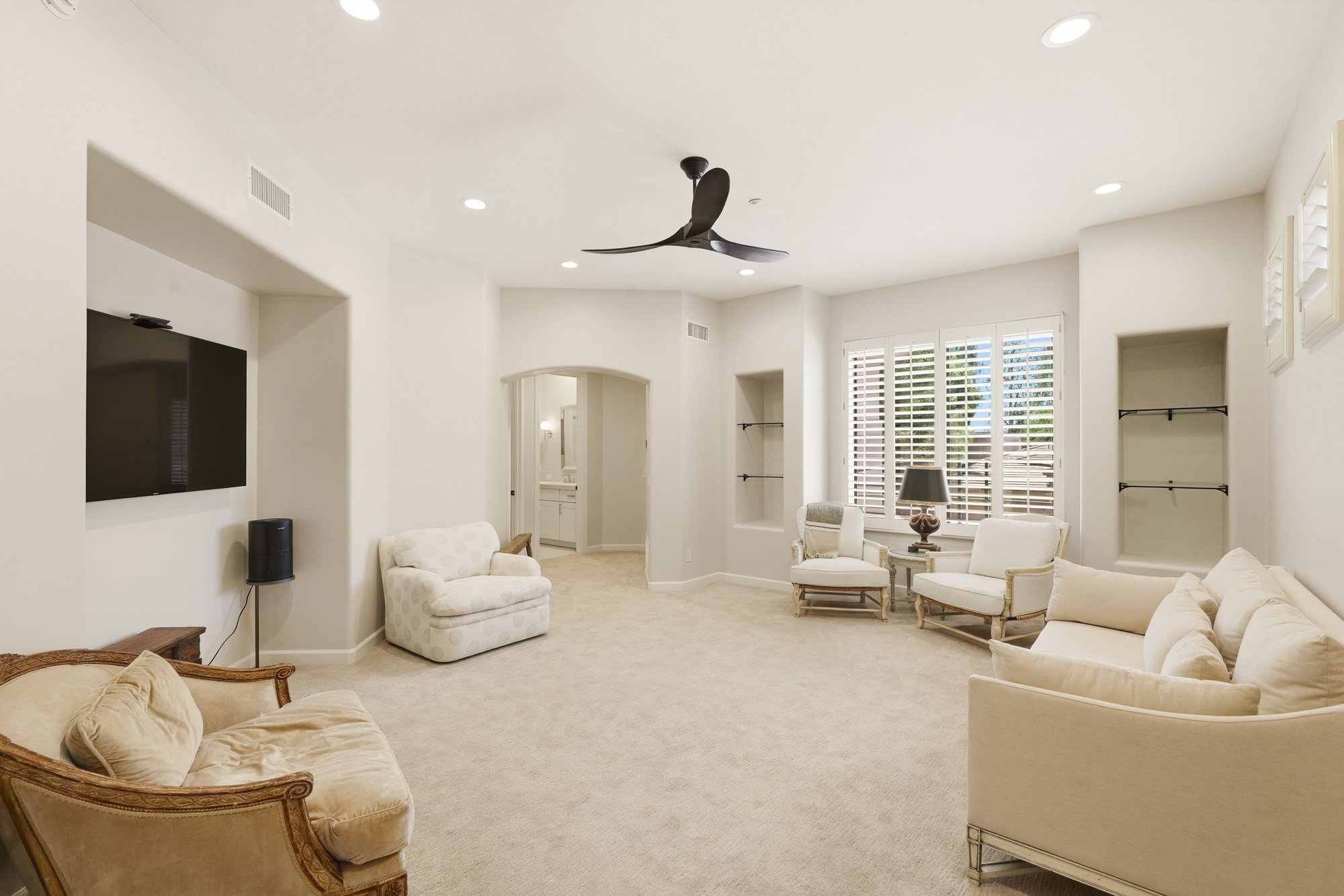 Living room with vaulted ceiling and tall windows