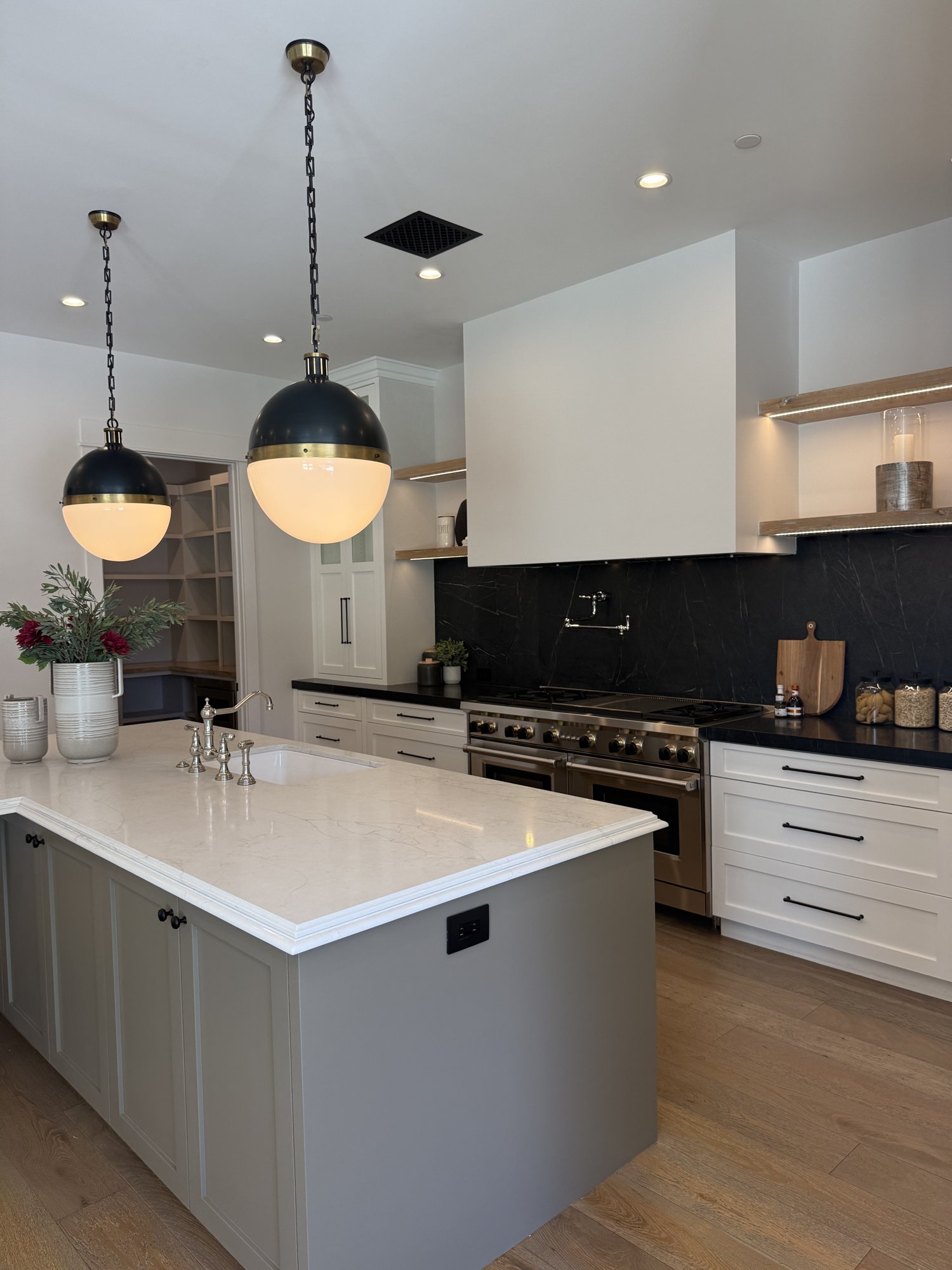 Kitchen with stone backsplash and globe pendant lighting in an Arcadia home