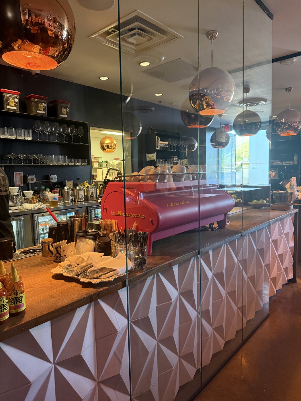 Pink tiled coffee bar counter with an espresso machine