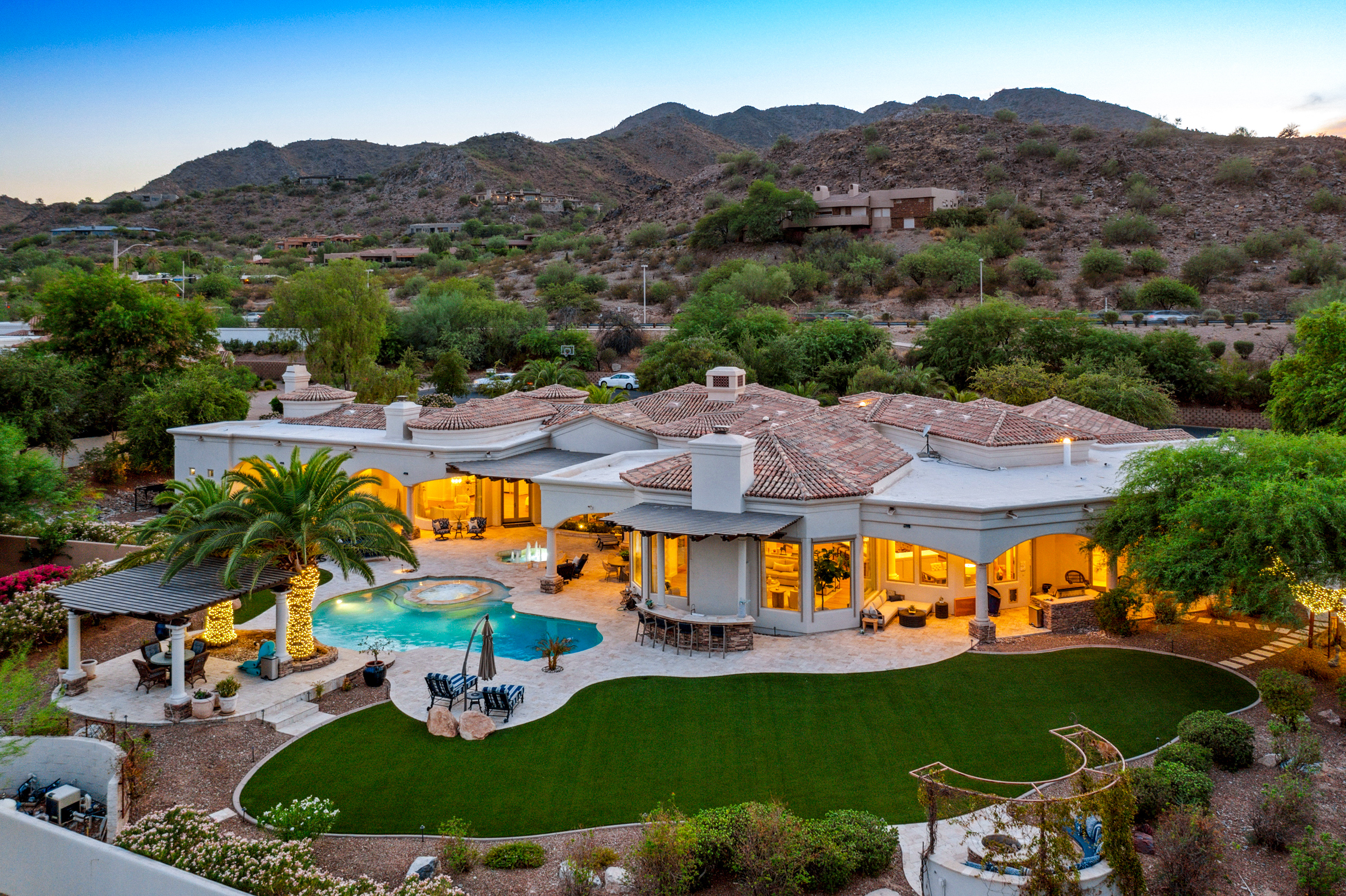 Twilight view of a Paradise Valley estate with mountain backdrop